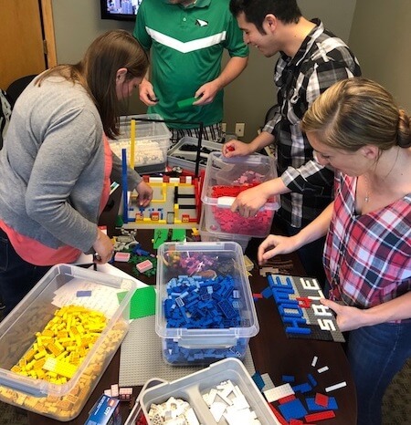IMG: group of people working on a lego project