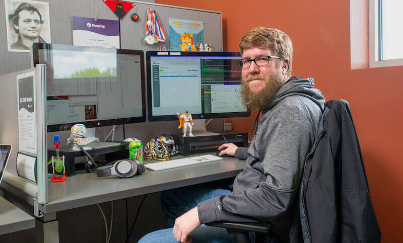 IMG: Andrew sitting at his desk at Firespring