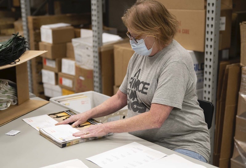 a print production specialist working on a direct mail piece.