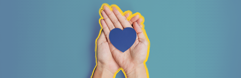 Two hands holding a blue, cut out heart. Showing thanks.
