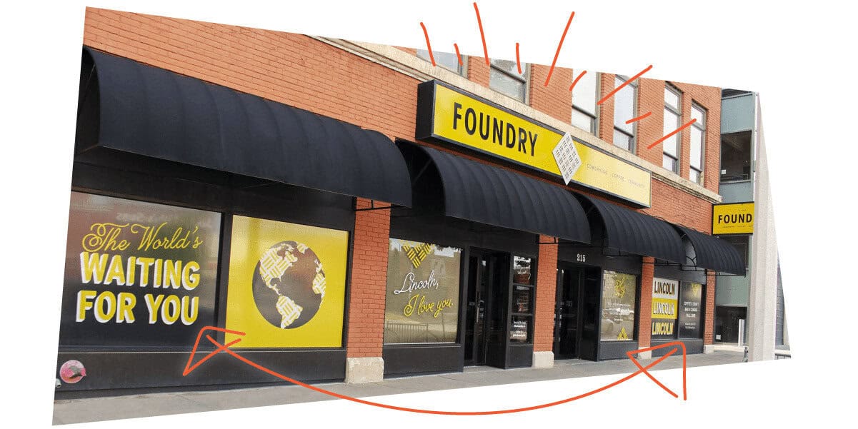 Photo of building with arrows pointing to signage, giving an example of outdoor signage.